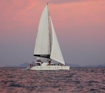 As the sun sets, enjoy the thrill of pure sailing on Sailaway V, a luxury Lagoon 500 sailing catamaran