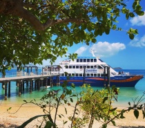 Passengers travel on-board a large air-conditioned catamaran